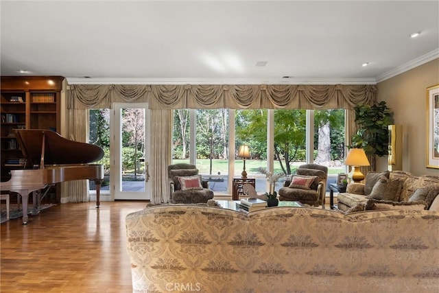 living area featuring ornamental molding and wood finished floors