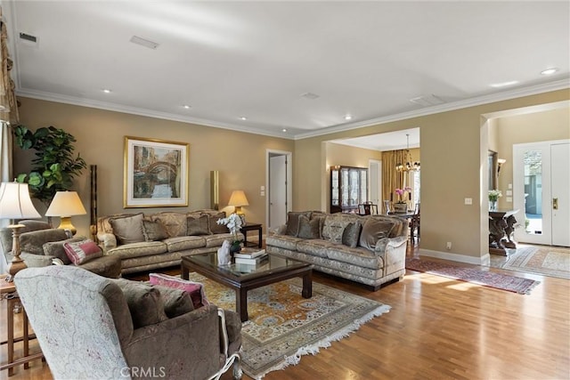 living room with crown molding, baseboards, wood finished floors, and recessed lighting