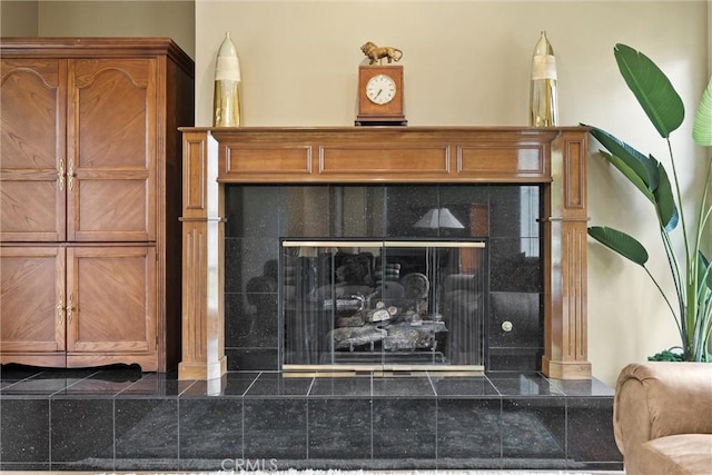 interior details featuring a tiled fireplace