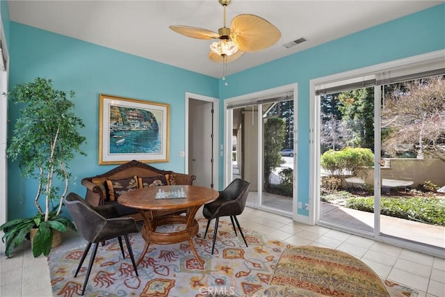 dining area with a wealth of natural light, visible vents, ceiling fan, and light tile patterned flooring