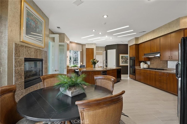 dining space featuring a fireplace and visible vents