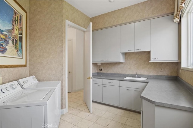 laundry area featuring cabinet space, a sink, and washing machine and clothes dryer