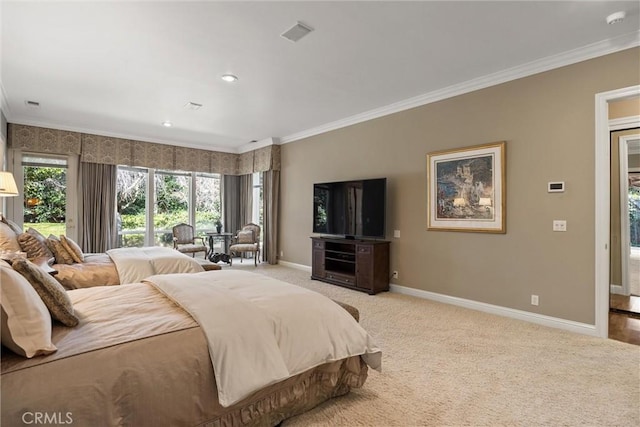 carpeted bedroom with ornamental molding and baseboards