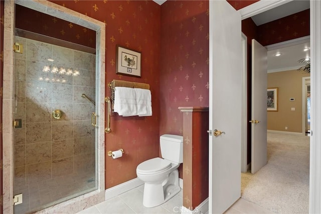 full bath featuring a stall shower, baseboards, tile patterned flooring, and toilet