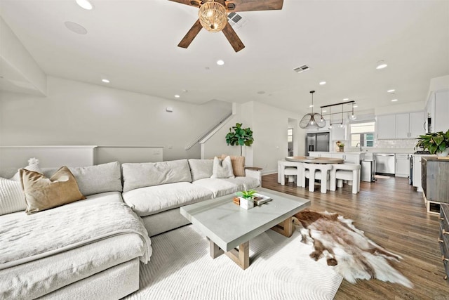 living area featuring dark wood finished floors, visible vents, and recessed lighting