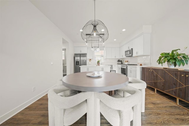 dining area with a chandelier, recessed lighting, dark wood-style flooring, and baseboards