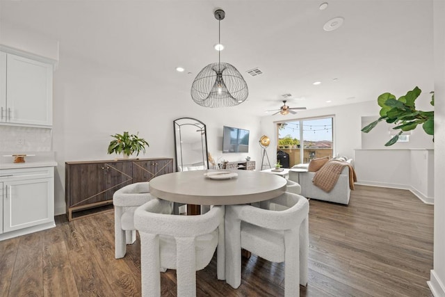 dining room featuring recessed lighting, dark wood finished floors, visible vents, and baseboards