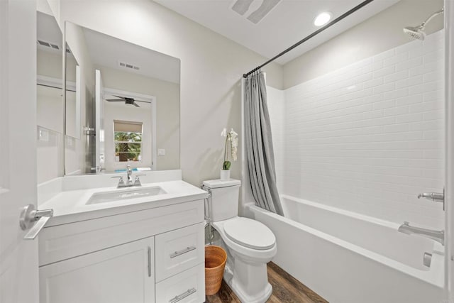 full bathroom with toilet, shower / tub combo, wood finished floors, vanity, and visible vents