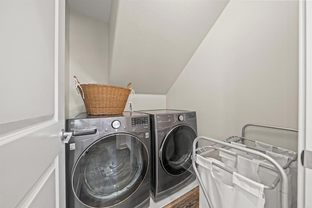 washroom featuring laundry area, washer and clothes dryer, and wood finished floors