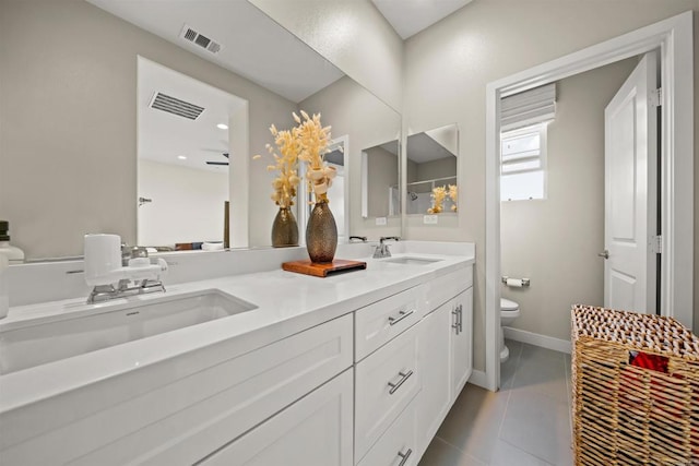 bathroom featuring toilet, visible vents, a sink, and tile patterned floors