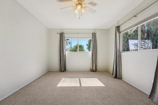 carpeted empty room featuring ceiling fan