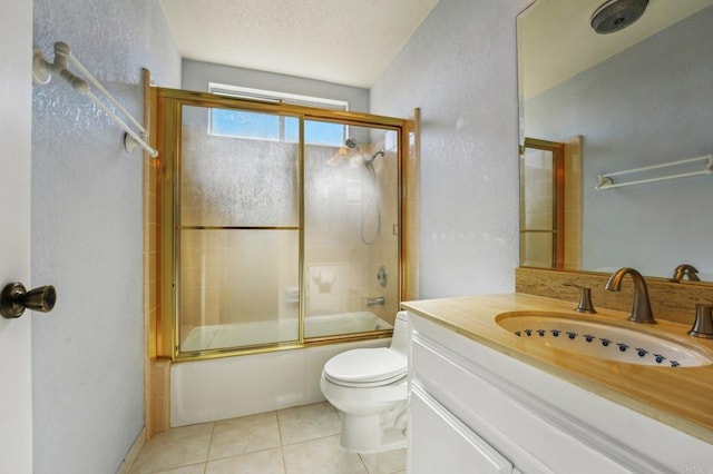 full bath with toilet, tile patterned floors, combined bath / shower with glass door, a textured ceiling, and vanity