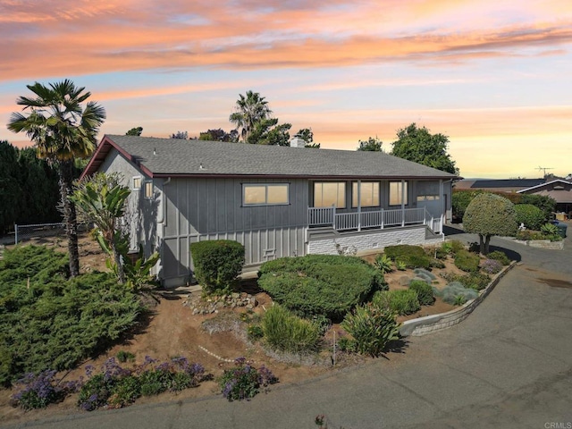 view of front of house with a shingled roof and driveway