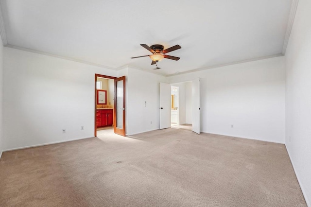 empty room featuring ceiling fan, ornamental molding, and light colored carpet