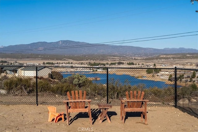 surrounding community featuring a mountain view and fence