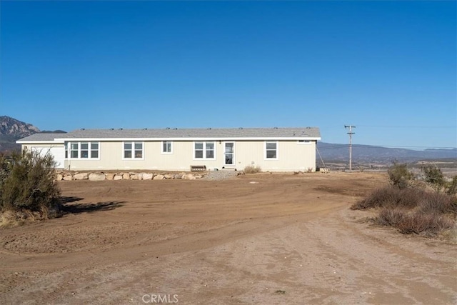 back of property with a mountain view