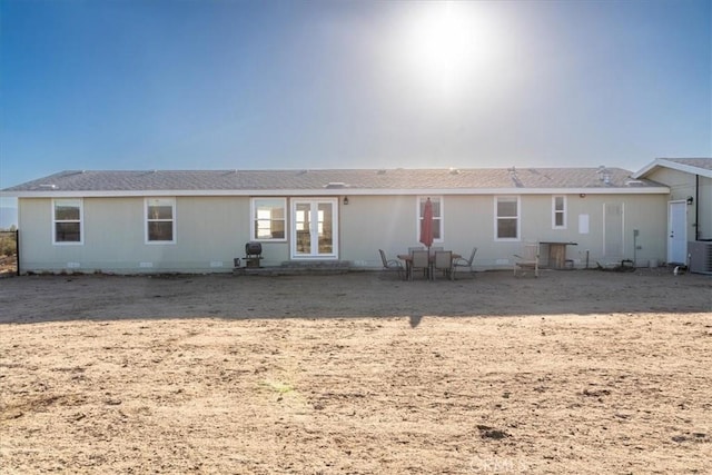 back of property featuring crawl space and french doors