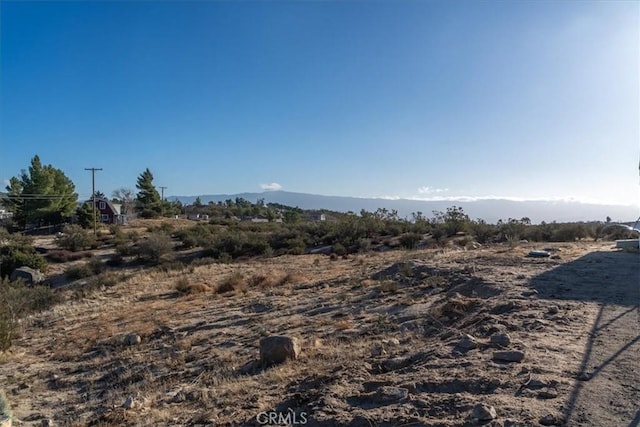 view of landscape with a rural view and a mountain view