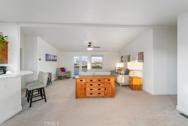 living room featuring a ceiling fan, light carpet, lofted ceiling with beams, and baseboards