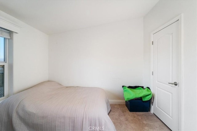 bedroom featuring light colored carpet