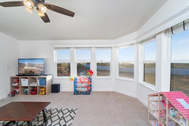 game room featuring light carpet, plenty of natural light, and baseboards