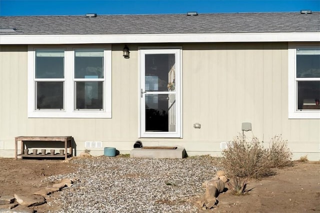 doorway to property with crawl space and roof with shingles