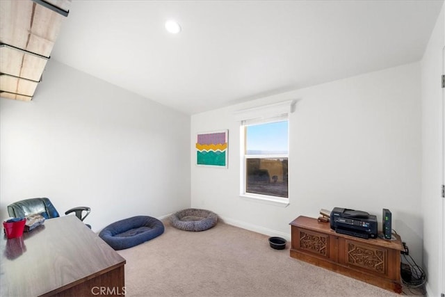 carpeted home office with baseboards