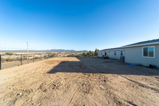 view of yard featuring a rural view, cooling unit, and fence