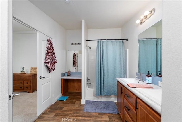 bathroom featuring shower / bath combo with shower curtain, wood finished floors, and vanity