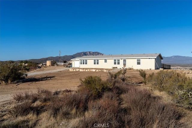 back of house featuring a mountain view