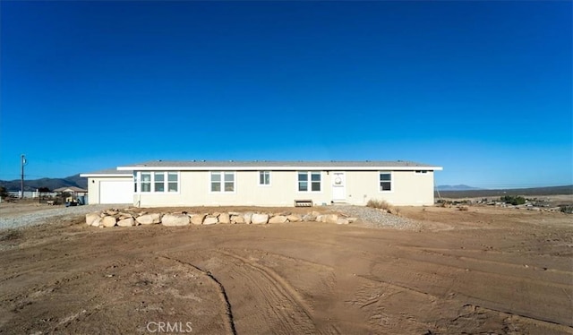 view of front of home with a mountain view, driveway, and an attached garage