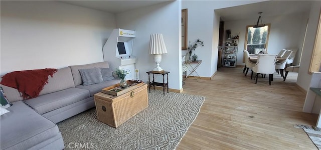 living room featuring light wood-type flooring and baseboards