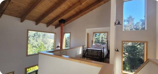 interior space featuring plenty of natural light, wood ceiling, high vaulted ceiling, and beam ceiling