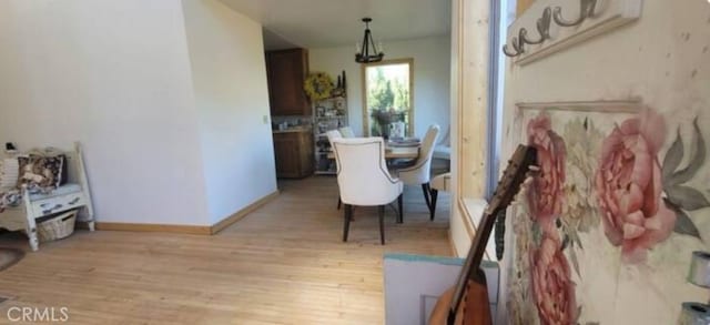 dining room with light wood-style floors and baseboards