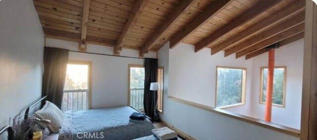 unfurnished bedroom featuring lofted ceiling with beams and wood ceiling