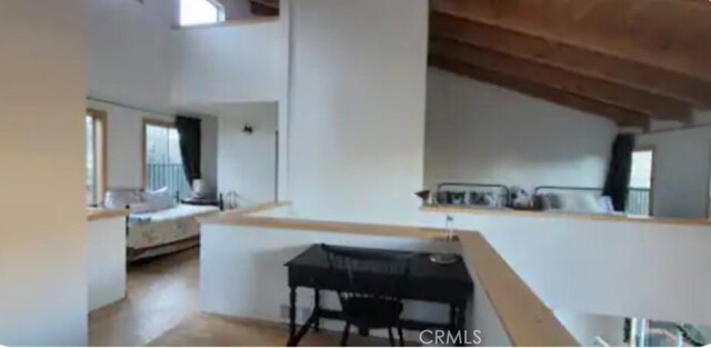 kitchen with light countertops, beamed ceiling, and plenty of natural light