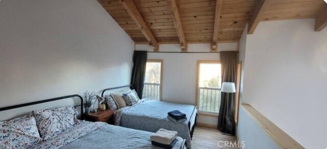 unfurnished bedroom with light wood finished floors, multiple windows, wooden ceiling, and beam ceiling