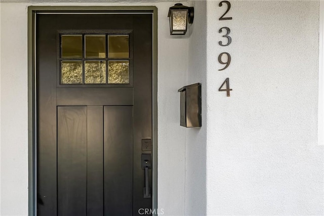 doorway to property with stucco siding