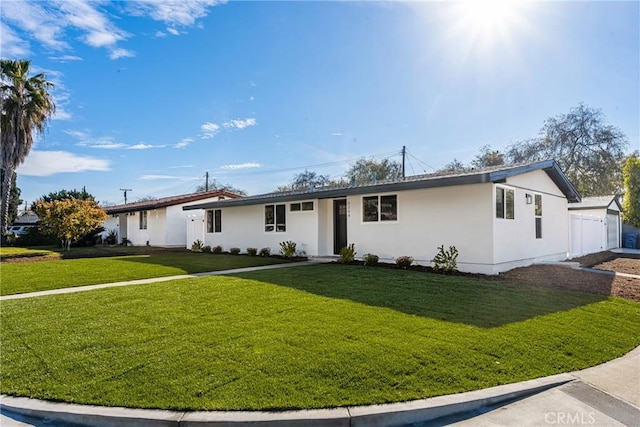 ranch-style home featuring a front yard and stucco siding