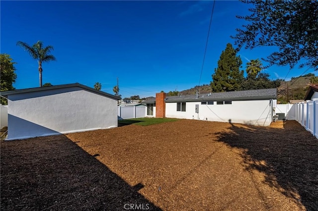 view of yard with a fenced backyard and a gate