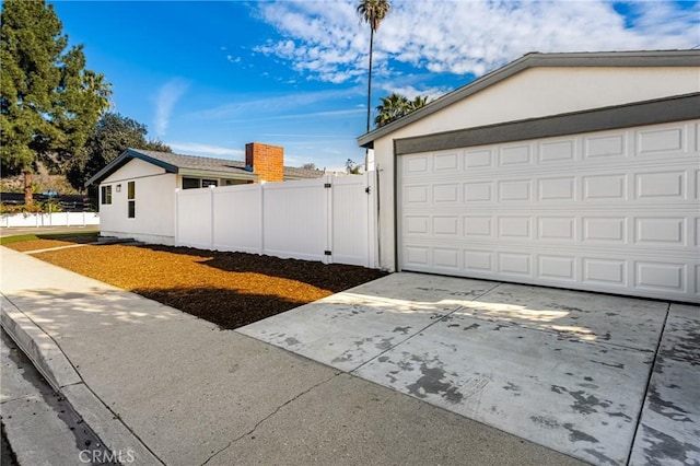 view of home's exterior featuring fence and stucco siding