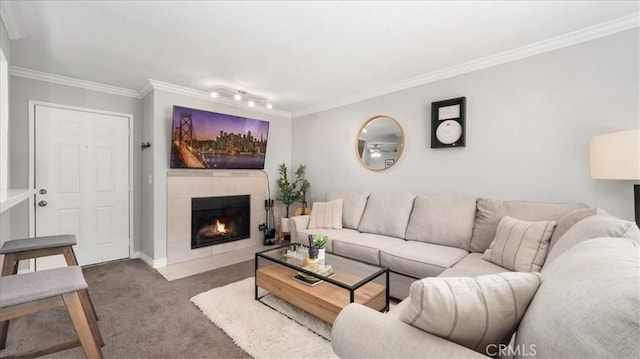 living room featuring carpet floors, ornamental molding, a fireplace, and baseboards