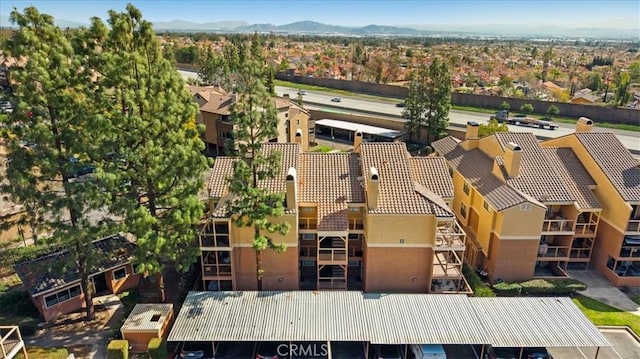 drone / aerial view featuring a residential view and a mountain view