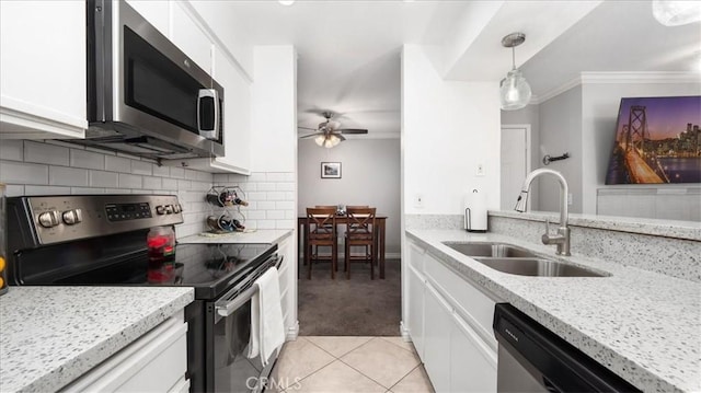 kitchen featuring appliances with stainless steel finishes, a sink, and white cabinetry