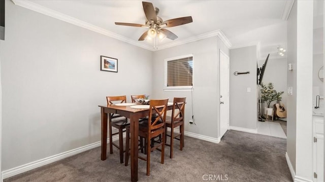 dining room featuring baseboards, dark carpet, and crown molding