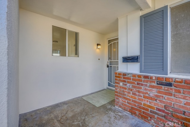 doorway to property with stucco siding