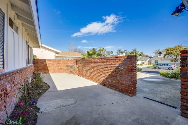 view of patio / terrace with a fenced backyard and a residential view