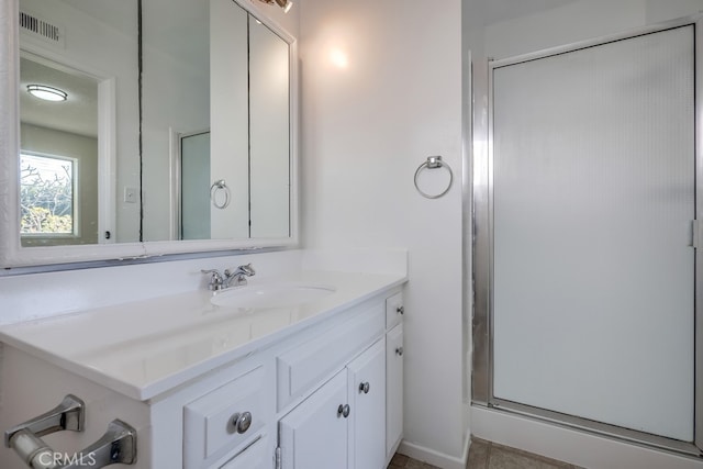 full bathroom featuring visible vents, vanity, and a shower stall