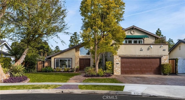 view of front facade with concrete driveway, stone siding, an attached garage, a front lawn, and stucco siding