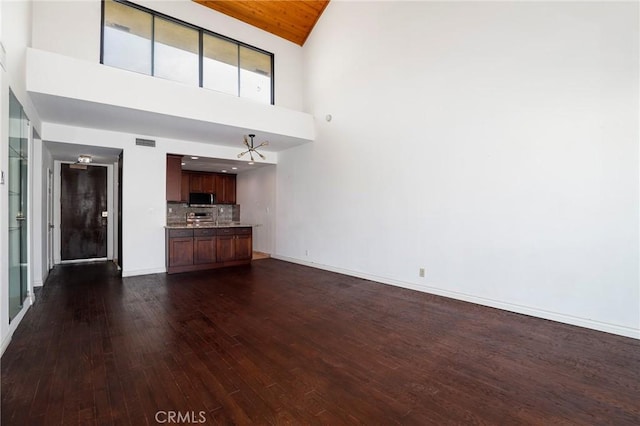 435 S La Fayette Park Pl Unit 311, Los Angeles, CA 90057 - unfurnished living room featuring high vaulted ceiling, dark wood finished floors, and baseboards
